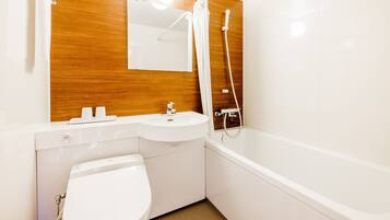 A modern bathroom with a wooden vanity, a white sink, a toilet, and a bathtub.