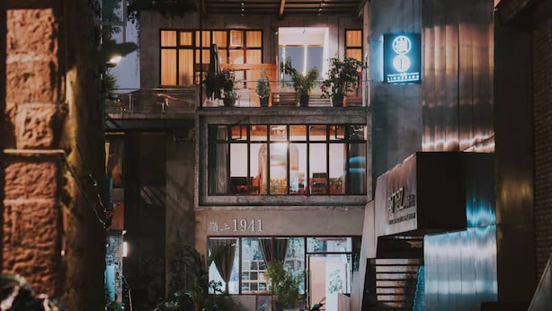 A two-story building with a sign reading "1941" and a neon sign above the entrance. - Lingshang 1941 Inn (Chongqing)