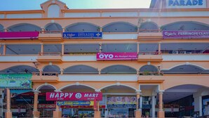 A multi-story shopping mall with various stores including Eden Parade, OYO My Budget Home, and Happy Mart. - Hotel O My Budget Home (George Town)