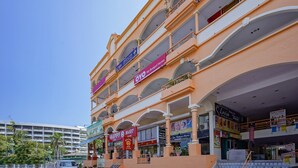 A multi-story shopping mall with various stores including a budget home, a tailor, and a florist. - Hotel O My Budget Home (George Town)