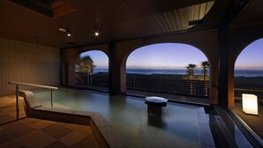 A modern indoor pool area with a view of the ocean, wooden ceiling, and a bench. - Tateyama Onsen Senri no Kaze (Tateyama)