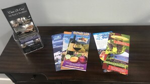 A brochure stand with a 'Casa Di Cass' brochure, a 'Tasting Map' brochure, and a 'Grant County Washington' brochure.