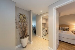 A modern bedroom with a bed, a nightstand, and a wall-mounted artwork. - Apartment M311 - spacious and relaxed apartment! (Scarborough)