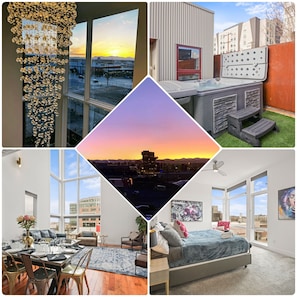 Enjoy a panoramic city view from the comfort of this stylish room, featuring a large bed, seating area, and balcony with hot tub.
