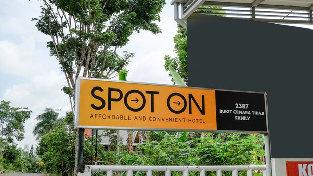 A sign for a hotel named "SPOT ON" with a description "AFFORDABLE AND CONVENIENT HOTEL." - SPOT ON 2387 Bukit Cemara Tidar Family (Malang)