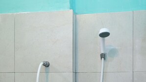 A shower with a handheld hose and a wall-mounted showerhead. - OYO 2389 Kostel 99 (Pangkalpinang)