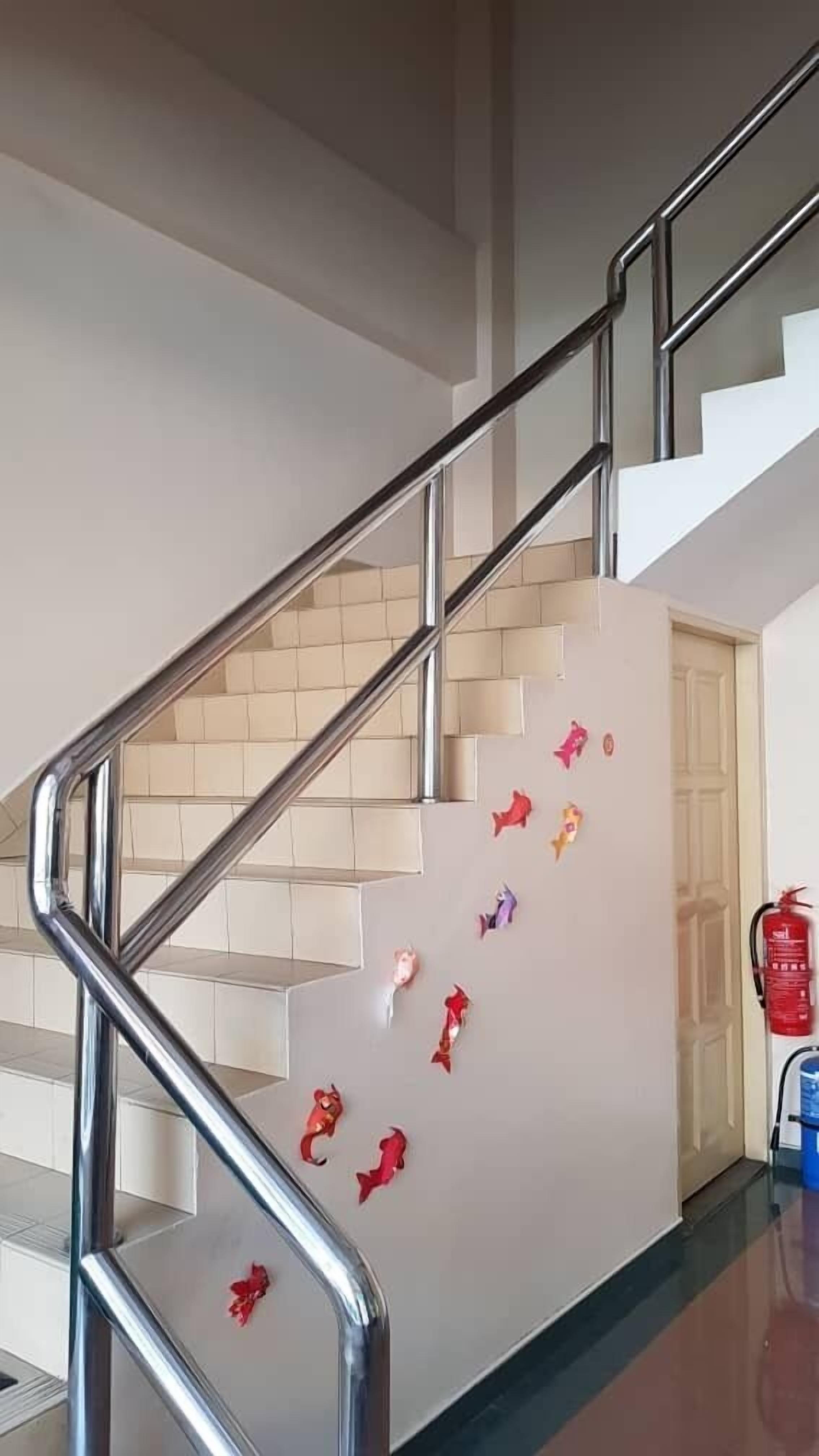 A staircase with metal railings and beige steps.