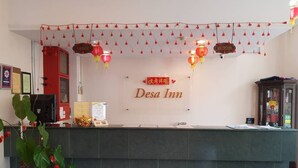 A reception desk with a sign reading "Desa Inn" and red lanterns above. - Desa Inn Hotel (Kuala Pilah)