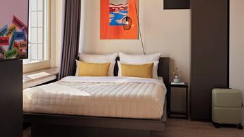 A hotel room with a bed, a nightstand, a lamp, a small table with a vase, and a wardrobe.