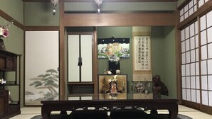 A traditional Japanese room with tatami flooring, a low wooden bench, a shoji screen, and a calligraphy scroll. - Ryu (Hatsukaichi)
