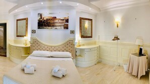 A luxurious bedroom with a large bed, a television, a vanity with a mirror, and a painting of a historical building on the wall. - Simon's Guest House Rome (Rome)