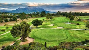 A golf course with a mountain backdrop, well-maintained grass, and a few trees. - The Jade Estate Somerset West (Cape Town)