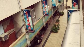 A narrow alleyway between buildings with signage indicating a restaurant.