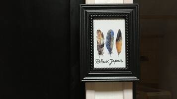 A framed picture of Black Tarpan feathers on a wall.