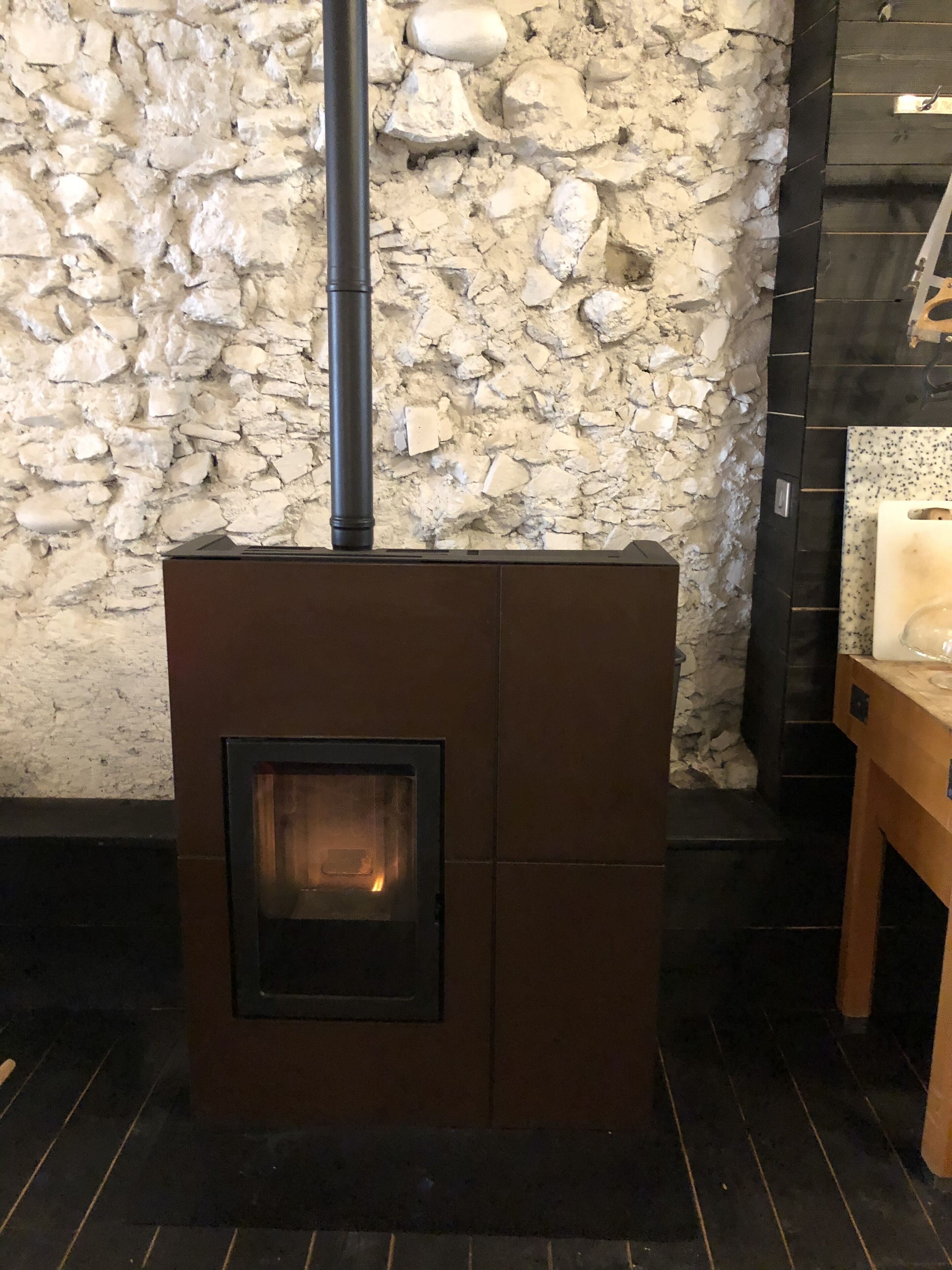 A stone wall with a fireplace.