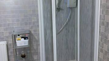 Separate bathtub and shower, hair dryer, towels, soap