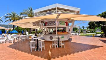 A café with outdoor seating, a counter, and a sign that reads "THEA'S".