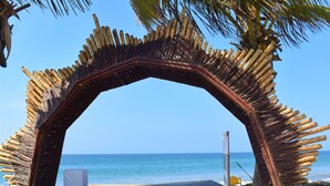 An archway made of bamboo sticks at a beach. - qema Mancora (Máncora)