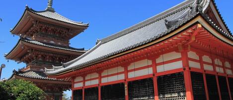 A traditional Japanese temple with a multi-tiered pagoda and a main hall with red and white walls.