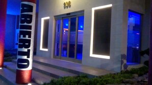 A building entrance with illuminated signage and a glass door. - Hotel Plaza Arteaga (Monterrey)