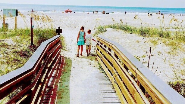 A wooden boardwalk leading to a beach with sand dunes and a clear view of the ocean. - Location! Location! Townhouse.    STR Permit #: 040846 (Hilton Head)