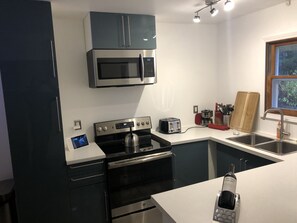 Enjoy cooking in this well-equipped kitchen with a gas stove, oven, and microwave.