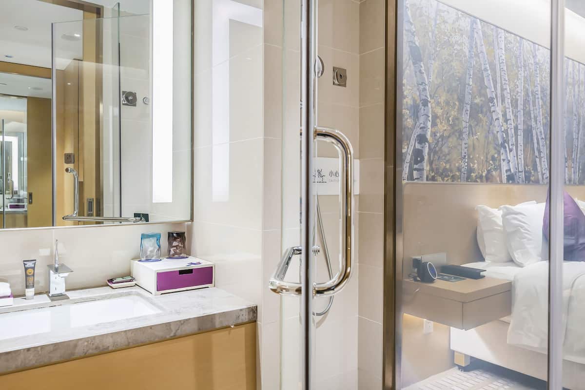 junior suite, 1 king bed | bathroom | rainfall showerhead, designer toiletries, hair dryer, bathrobes