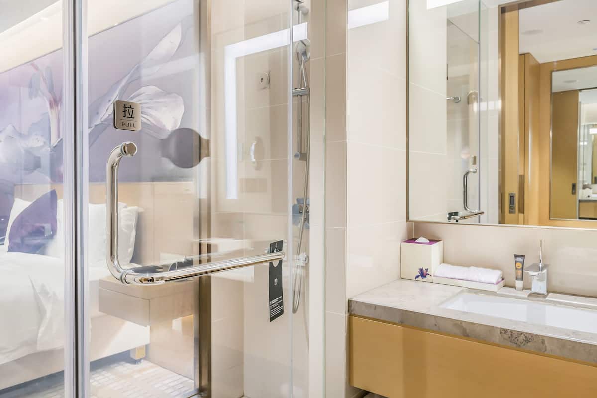 junior suite, 1 king bed | bathroom | rainfall showerhead, designer toiletries, hair dryer, bathrobes