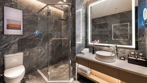 A modern bathroom with a glass-enclosed shower, a large mirror, and a white sink. - Shenzhen Longgang Kunyi Mercure Hotel (Shenzhen)