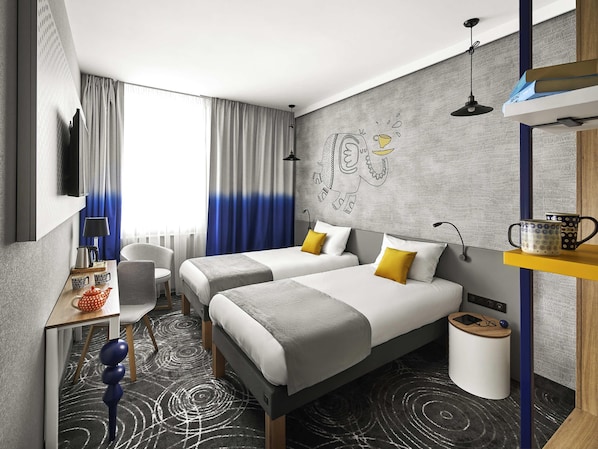 A modern hotel room with two beds, a desk, a chair, and a large window with curtains.