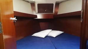 A compact cabin with a single bed, two pillows, and a small window. - Boat & Breakfast Leporello (Bisceglie)