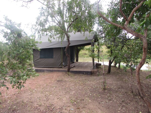 A tented camping area with a platform and a small step leading to the entrance. - Naumba Camp Site (Ngoma)