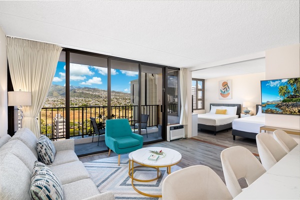 Relax and enjoy this beautiful condo with a mountain view, a pull-out sleeper sofa, a coffee table, a chair, and a flat-screen TV.