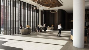 A modern lobby with a wooden ceiling, large windows, and a reception desk. - Novotel Perth Murray Street (Perth)