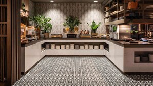 A modern kitchen with patterned tiles, wooden shelves, and potted plants.