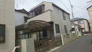 A modern two-story building with a covered entrance and a metal fence. - Funabori Hasui (Tokyo)