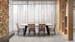 A dining area with a stone wall, a large window with sheer curtains, and wooden shelving units. - Fairfield Inn & Suites by Marriott Tampa Riverview (Riverview)
