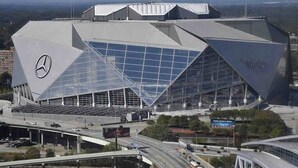 A modern stadium with a Mercedes-Benz logo, large glass panels, and a unique geometric design. - Prime Downtown Atlanta Condo with Luxury Amenities (Atlanta)