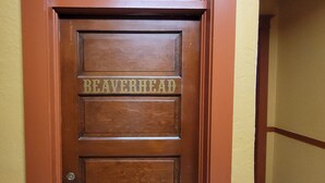 A wooden door with the name "BEAVERHEAD" carved into it. - Dillon Tap House Beaverhead Room (Dillon)