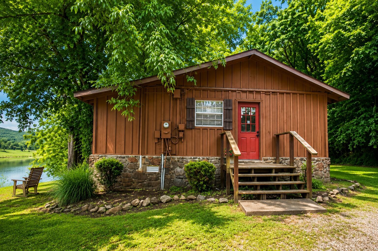 A wooden cabin with a red door, stone foundation, and a wooden staircase leading to the entrance.