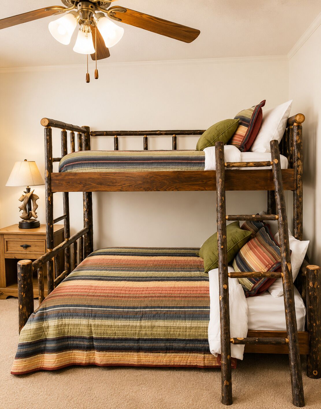 A bunk bed with a striped bedspread, a wooden headboard, and a ceiling fan.