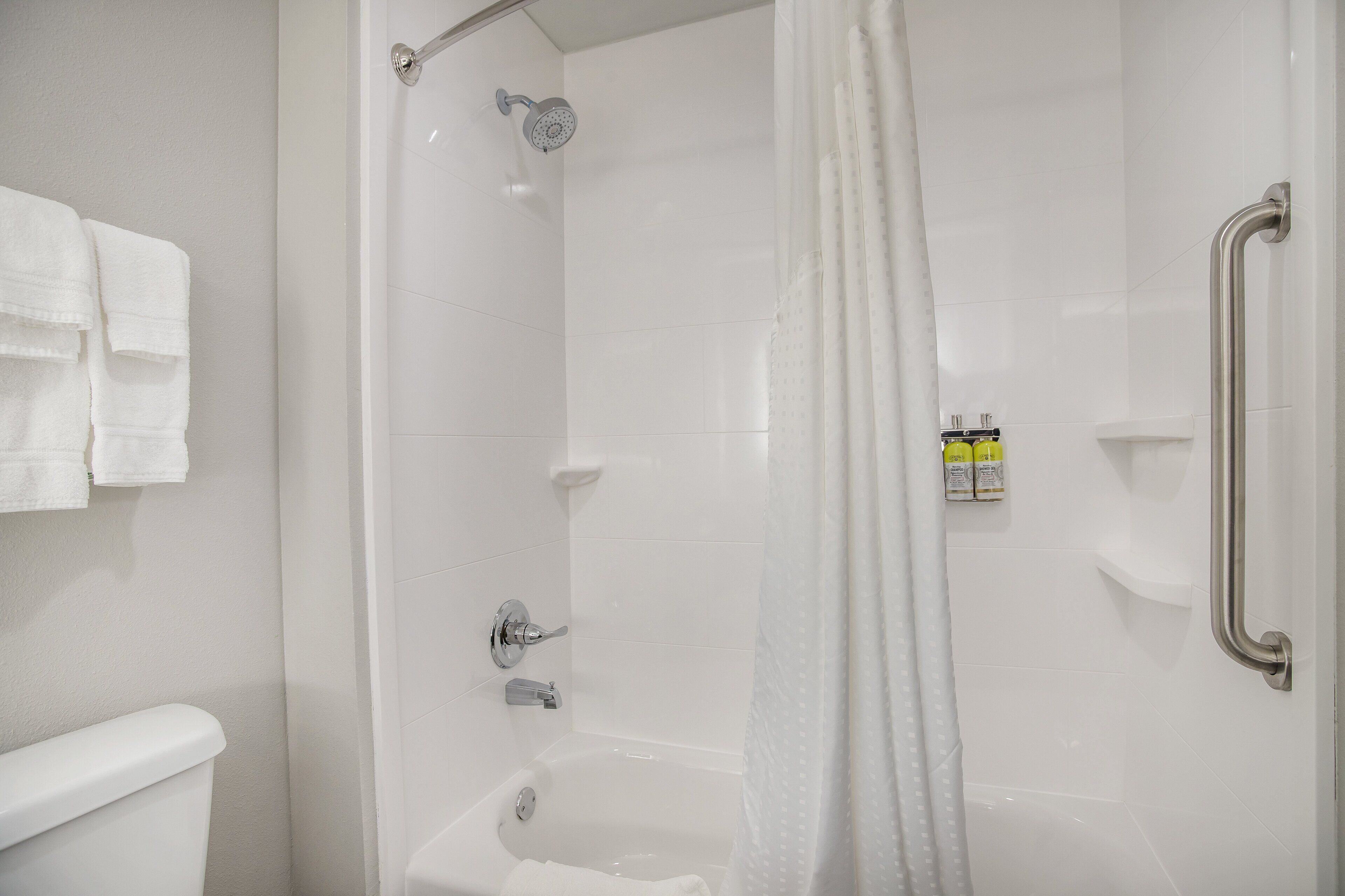 combined shower/bathtub, designer toiletries, hair dryer, towels