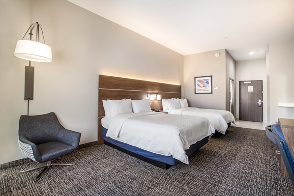 A hotel room with a large bed, a chair, a desk, and a lamp. - Holiday Inn Express & Suites Tulsa East - Catoosa by IHG (Tulsa)