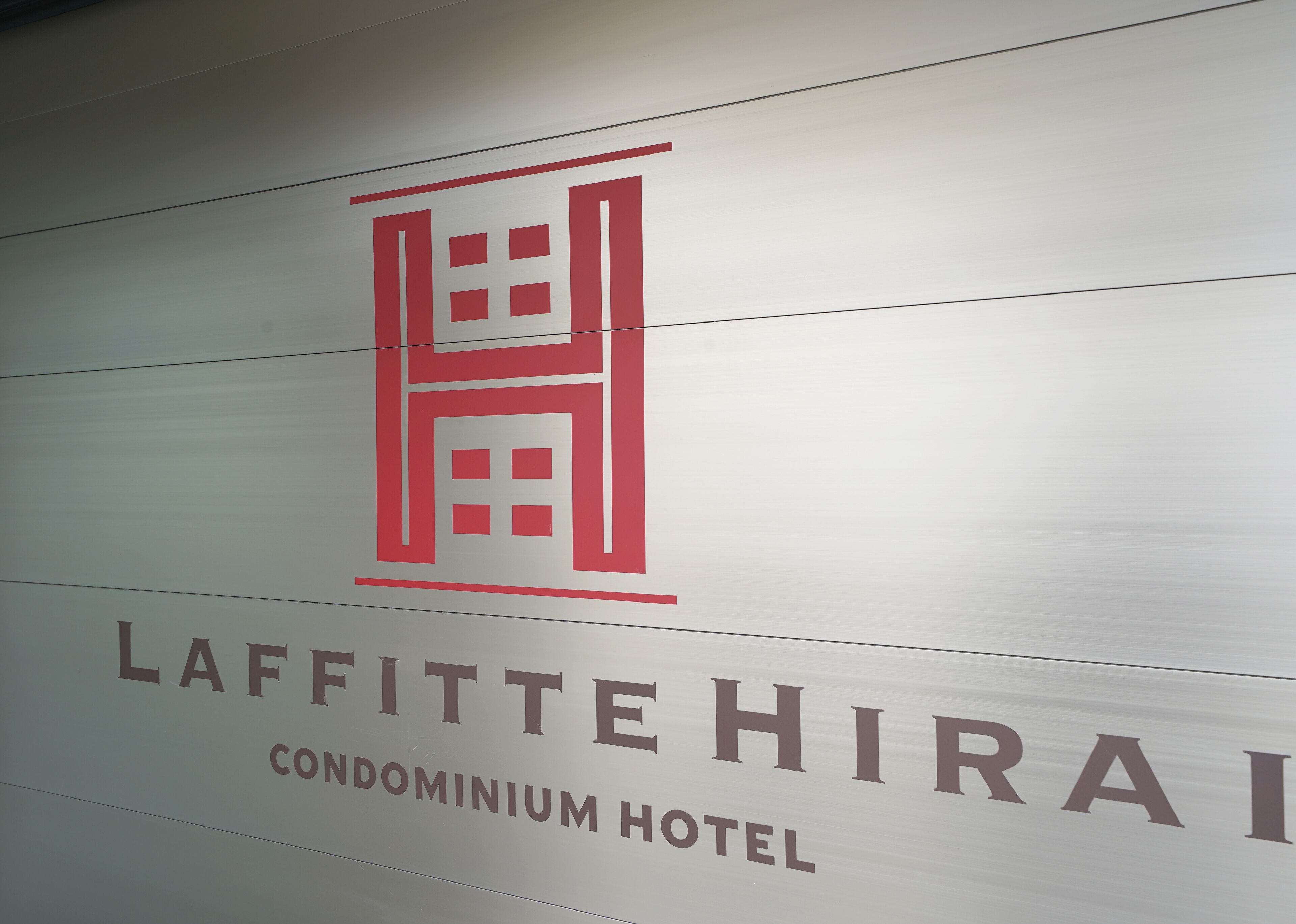A sign for the Laffitte Hira Condominium Hotel.