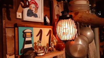 A shelf with a lighthouse cutout, a number '11', and various figurines.