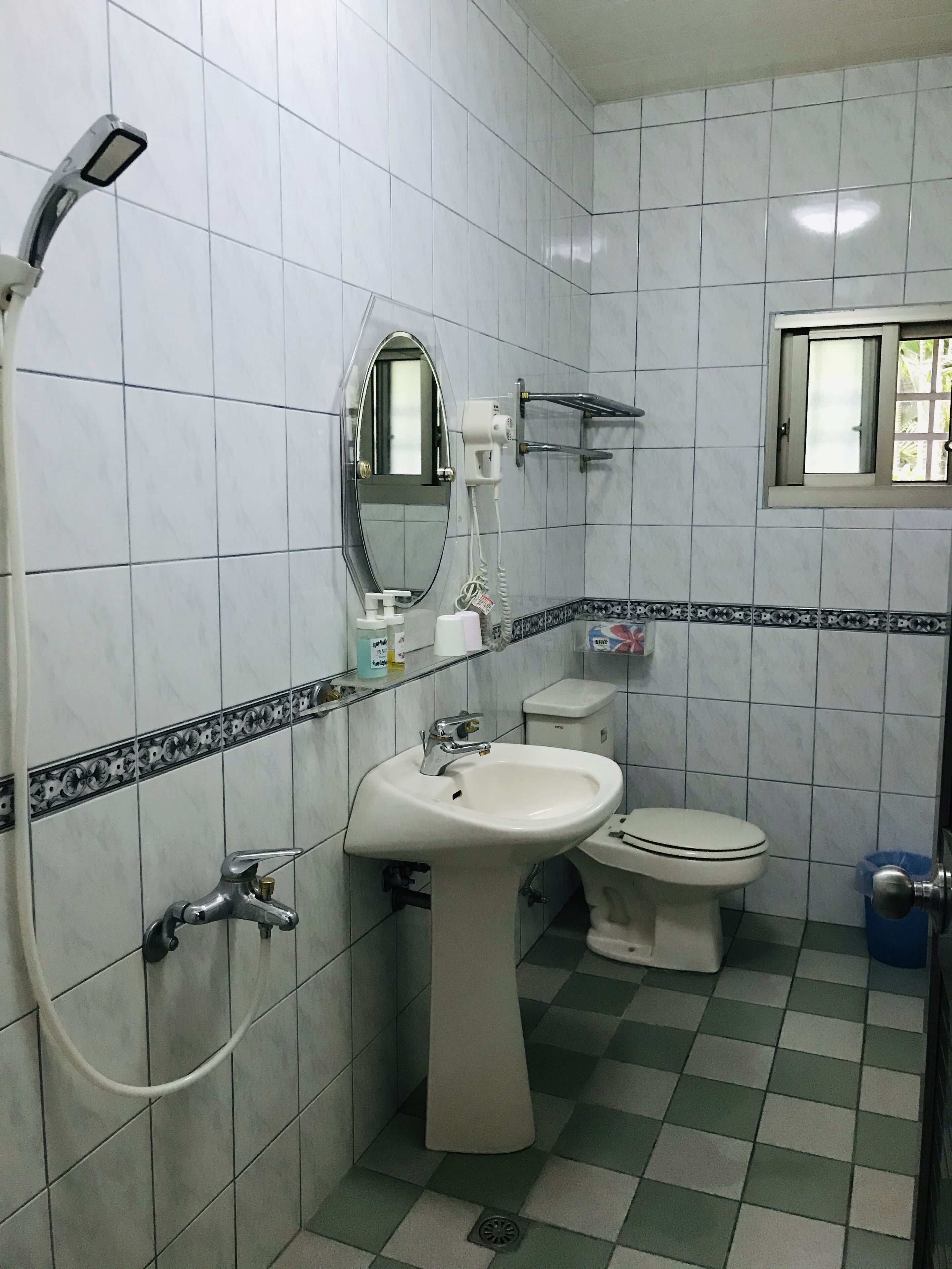 A bathroom with a sink, toilet, and shower.