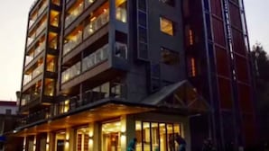 A multi-story hotel with balconies and a ground-level entrance. - Qing Gu Ju (Zhaoqing)