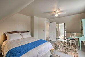 A bedroom with a bed, a ceiling fan, a chair, and a desk. - Near Lakes, Bay & Trails! Historic Waldoboro Gem (Waldoboro)