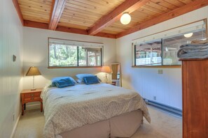 A bedroom with a bed, two bedside tables, a window, and a heater. - 6 Mi to Yosemite Nat'l Park: 14-Acre Retreat! (Groveland)