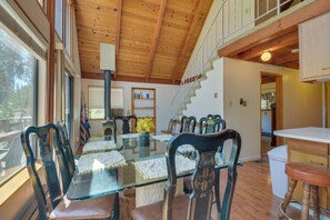 A dining area with a glass table, wooden chairs, and a staircase leading to an upper level. - 6 Mi to Yosemite Nat'l Park: 14-Acre Retreat! (Groveland)